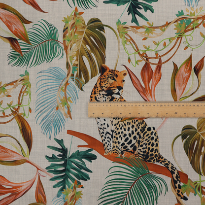 Fabric pattern featuring lounging leopards surrounded by vibrant tropical leaves, monstera fronds, and vines on a light-coloured background.