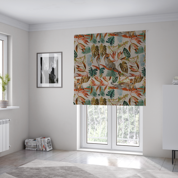 The fabric used to create these Roman blinds is a lounging leopards surrounded by vibrant tropical leaves, monstera fronds, and vines on a light-coloured background.