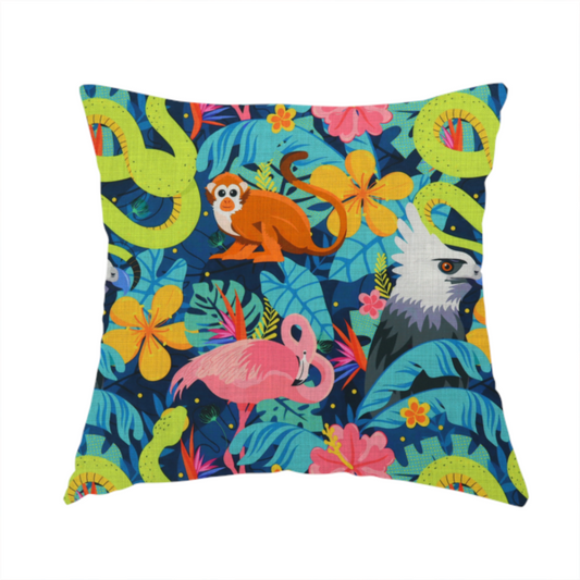 The fabric used to create this handmade cushion has neon green snakes, orange monkeys, pink flamingos, and harpy eagles surrounded by tropical flowers and blue foliage on a dark blue background.