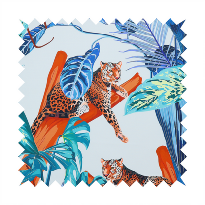 Pattern fabric featuring leopards resting on orange branches amidst vibrant blue and turquoise tropical leaves and foliage against a light background.