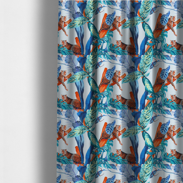 The fabric used to create these made-to-measure curtains has leopards resting on orange branches amidst vibrant blue and turquoise tropical leaves and foliage against a light background.