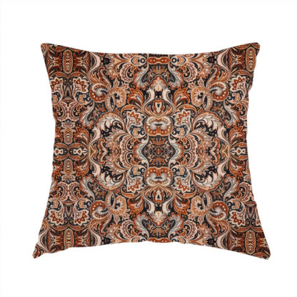 The fabric used to create this handmade cushion is a dense, intricate, and ornate paisley and damask-style repeating pattern featuring rich earth tones of copper, brown, cream, and dark charcoal.