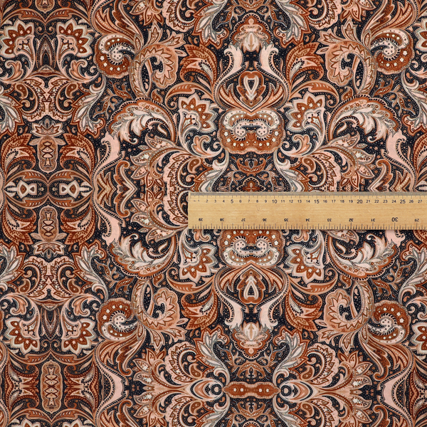 A dense, intricate, and ornate paisley and damask-style repeating pattern featuring rich earth tones of copper, brown, cream, and dark charcoal.