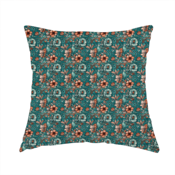 The fabric used to create this handmade cushion is a dense, intricate, vintage-style botanical repeating pattern featuring small orange and pale grey-blue flowers with detailed foliage set against a dark teal background.