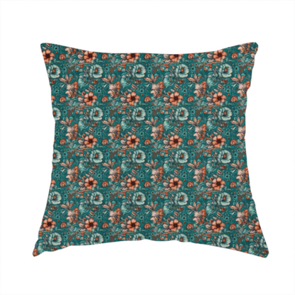 The fabric used to create this handmade cushion is a dense, intricate, vintage-style botanical repeating pattern featuring small orange and pale grey-blue flowers with detailed foliage set against a dark teal background.