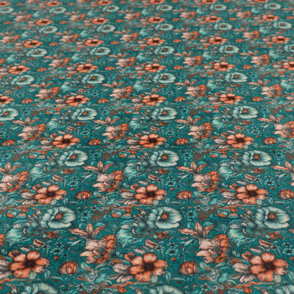 A dense, intricate, vintage-style botanical repeating pattern featuring small orange and pale grey-blue flowers with detailed foliage set against a dark teal background.
