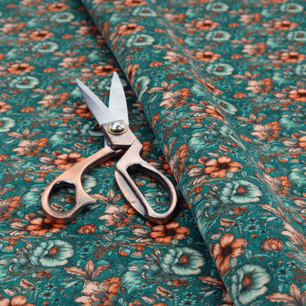 A dense, intricate, vintage-style botanical repeating pattern featuring small orange and pale grey-blue flowers with detailed foliage set against a dark teal background.