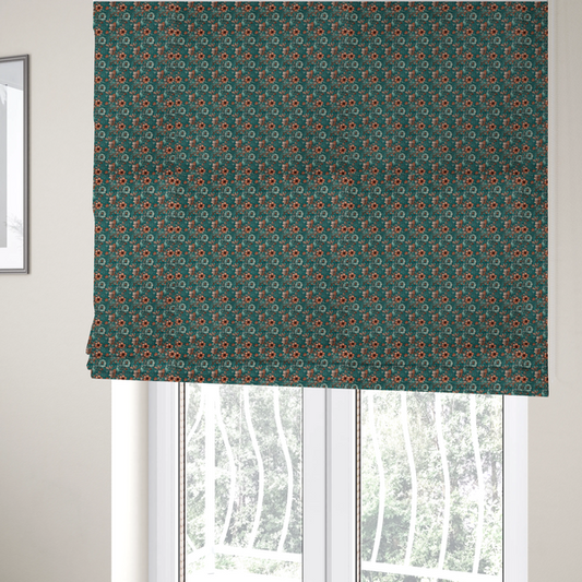 The fabric used to create these Roman blinds is a dense, intricate, vintage-style botanical repeating pattern featuring small orange and pale grey-blue flowers with detailed foliage set against a dark teal background.
