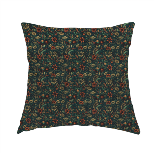 The fabric used to create this handmade cushion is a dense, dark, vintage-style botanical repeating pattern featuring small rust-red and pale yellow flowers interwoven with detailed dark green leaves and foliage against a deep dark background.