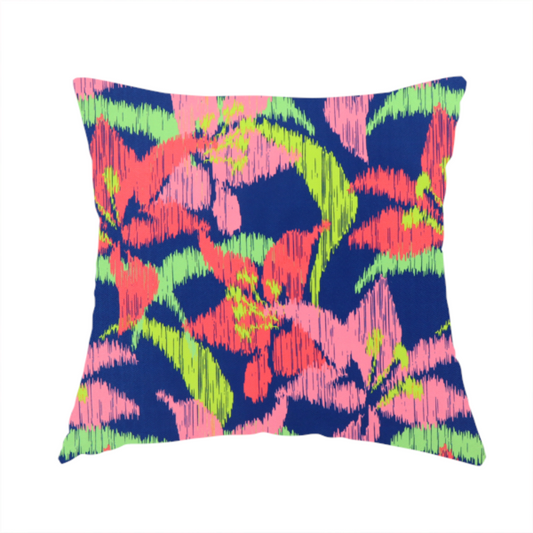 The fabric used to create this handmade cushion is a vibrant fabric pattern featuring large coral and light pink lily flowers with bright lime green leaves against a solid royal blue background.