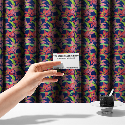 The fabric used to create these made-to-measure curtains is a vibrant fabric pattern featuring large coral and light pink lily flowers with bright lime green leaves against a solid royal blue background.