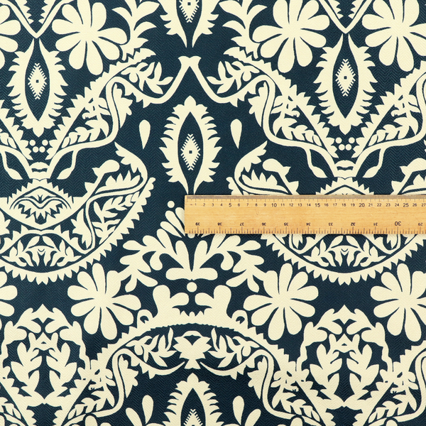 A dark midnight blue fabric featuring an ornate, repeating damask pattern in creamy off-white, composed of intricate scrollwork, floral motifs, and symmetrical ogee shapes.