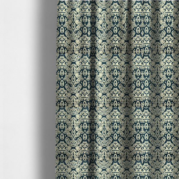The fabric used to create these made-to-measure curtains is a dark midnight blue fabric featuring an ornate, repeating damask pattern in creamy off-white, composed of intricate scrollwork, floral motifs, and symmetrical ogee shapes.