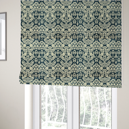 The fabric used to create these Roman blinds is a dark midnight blue fabric featuring an ornate, repeating damask pattern in creamy off-white, composed of intricate scrollwork, floral motifs, and symmetrical ogee shapes.