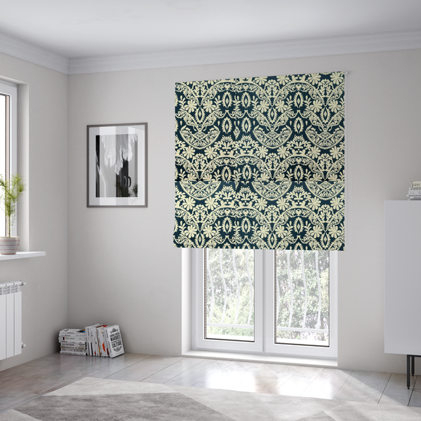 The fabric used to create these Roman blinds is a dark midnight blue fabric featuring an ornate, repeating damask pattern in creamy off-white, composed of intricate scrollwork, floral motifs, and symmetrical ogee shapes.