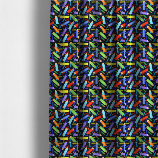 The fabric used to create these made-to-measure curtains is a black fabric featuring a playful, repeating pattern of coloured pencils in various shades including red, yellow, light blue, green, purple, and orange scattered diagonally across the background.