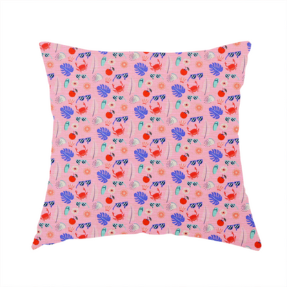 The fabric used to create this handmade cushion is a ink summer-themed fabric featuring a repeating pattern of tropical icons including crabs, sunglasses, cherries, flip-flops, palm leaves, citrus slices, and flowers.
