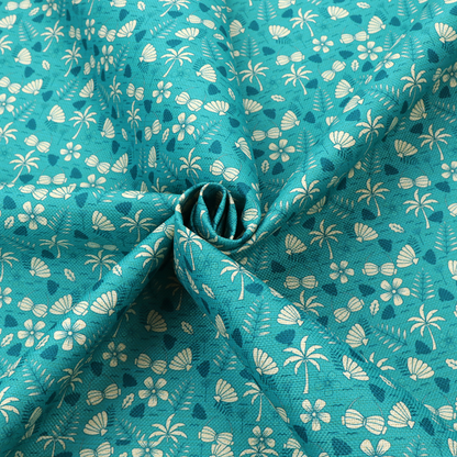 Teal summer-themed fabric featuring a repeating pattern of palm trees, seashells, flowers, and tropical foliage.