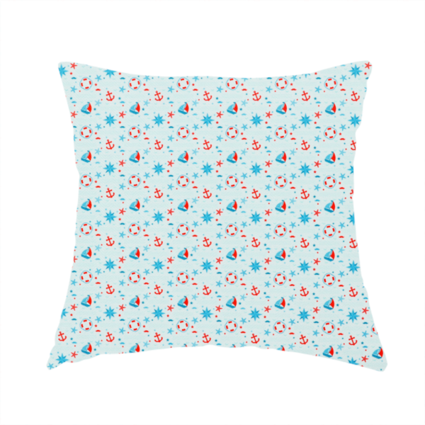 The fabric used to create this handmade cushion is a light blue fabric featuring a small-scale repeating nautical pattern of red anchors, lifebuoys, and sailboats, interspersed with blue and red stars.