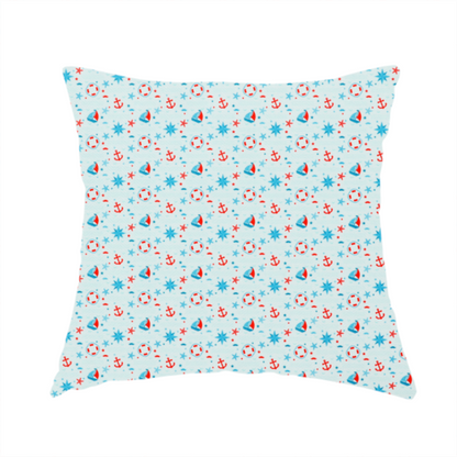 The fabric used to create this handmade cushion is a light blue fabric featuring a small-scale repeating nautical pattern of red anchors, lifebuoys, and sailboats, interspersed with blue and red stars.