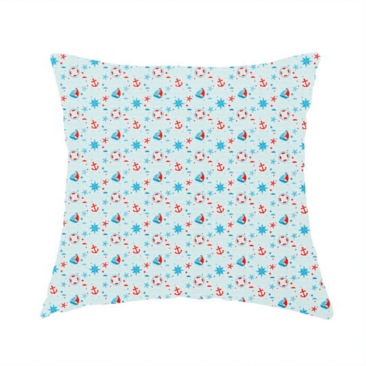 The fabric used to create this handmade cushion is a light blue fabric featuring a small-scale repeating nautical pattern of red anchors, lifebuoys, and sailboats, interspersed with blue and red stars.