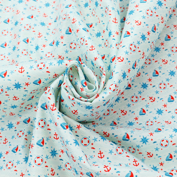 Light blue fabric featuring a small-scale repeating nautical pattern of red anchors, lifebuoys, and sailboats, interspersed with blue and red stars.