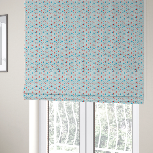 The fabric used to create these Roman blinds is a light blue fabric featuring a small-scale repeating nautical pattern of red anchors, lifebuoys, and sailboats, interspersed with blue and red stars.