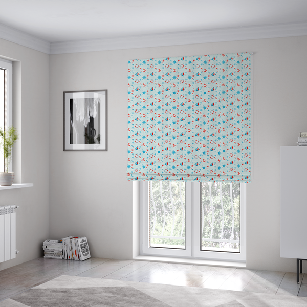 The fabric used to create these Roman blinds is a light blue fabric featuring a small-scale repeating nautical pattern of red anchors, lifebuoys, and sailboats, interspersed with blue and red stars.
