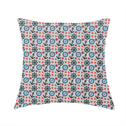 The fabric used to create this handmade cushion is a light blue fabric with a dense repeating nautical pattern featuring dark blue anchors, black ship wheels, blue compasses, red-and-white lifebuoys, and tiny red stars.