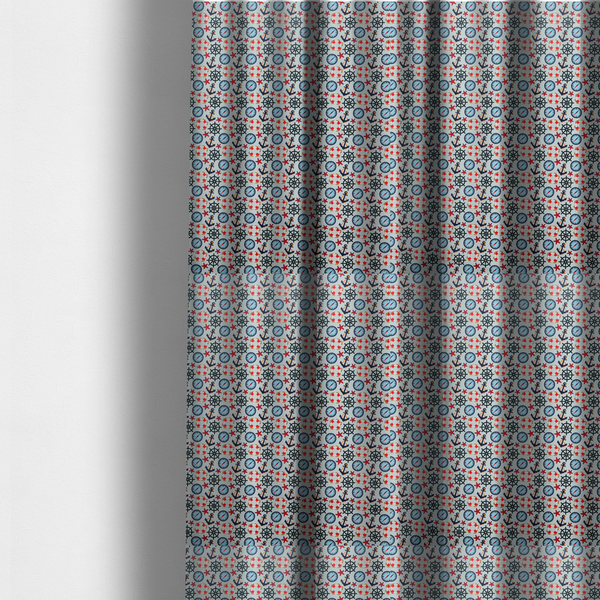 The fabric used to create these made-to-measure curtains is a light blue fabric with a dense repeating nautical pattern featuring dark blue anchors, black ship wheels, blue compasses, red-and-white lifebuoys, and tiny red stars.