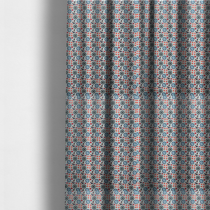 The fabric used to create these made-to-measure curtains is a light blue fabric with a dense repeating nautical pattern featuring dark blue anchors, black ship wheels, blue compasses, red-and-white lifebuoys, and tiny red stars.