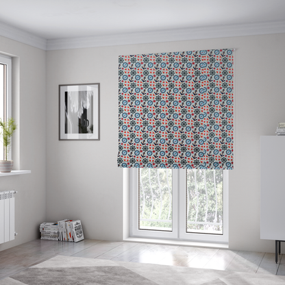 The fabric used to create these Roman blinds is a light blue fabric with a dense repeating nautical pattern featuring dark blue anchors, black ship wheels, blue compasses, red-and-white lifebuoys, and tiny red stars.