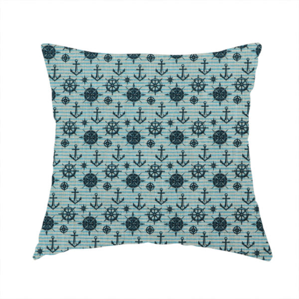 The fabric used to create this handmade cushion is a nautical-themed repeating pattern featuring dark blue anchors, ship wheels, compass roses, and stars over a light blue and dark blue striped background.