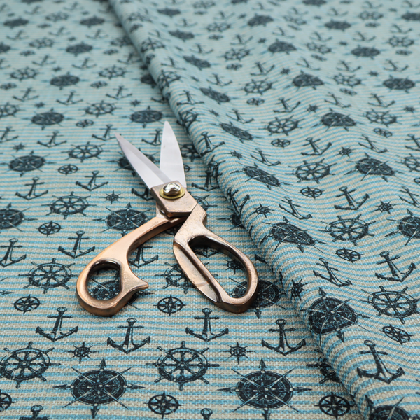 Nautical-themed repeating pattern featuring dark blue anchors, ship wheels, compass roses, and stars over a light blue and dark blue striped background.