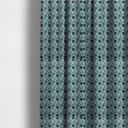 The fabric used to create these made-to-measure curtains is a nautical-themed repeating pattern featuring dark blue anchors, ship wheels, compass roses, and stars over a light blue and dark blue striped background.
