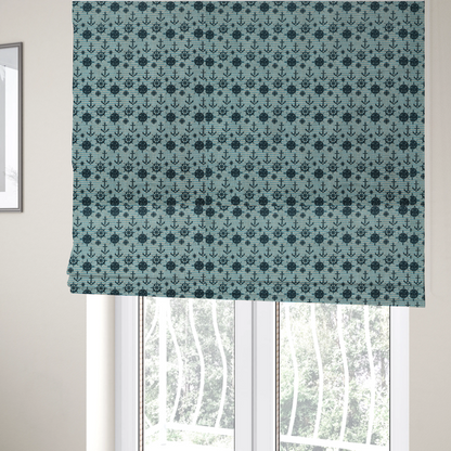 The fabric used to create these Roman blinds is a nautical-themed repeating pattern featuring dark blue anchors, ship wheels, compass roses, and stars over a light blue and dark blue striped background.