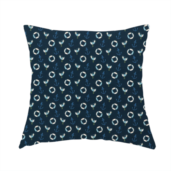 The fabric used to create this handmade cushion is a nautical-themed repeating pattern featuring seagulls, anchors, and life rings set against a dark blue background.