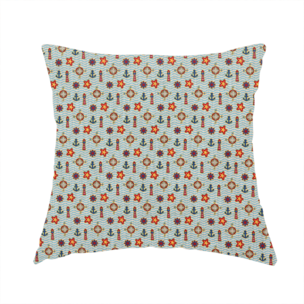 The fabric used to create this handmade cushion is a nautical-themed repeating pattern featuring lighthouses, anchors, compass stars, and starfish over a wavy-lined background.