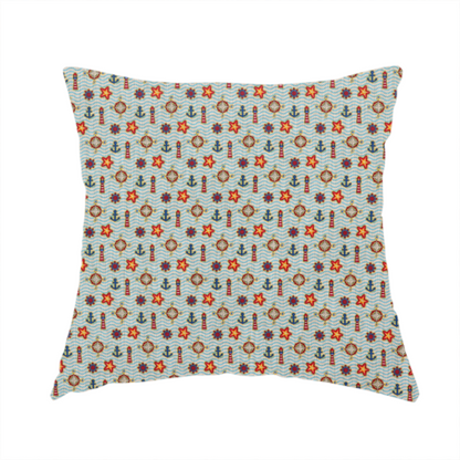 The fabric used to create this handmade cushion is a nautical-themed repeating pattern featuring lighthouses, anchors, compass stars, and starfish over a wavy-lined background.