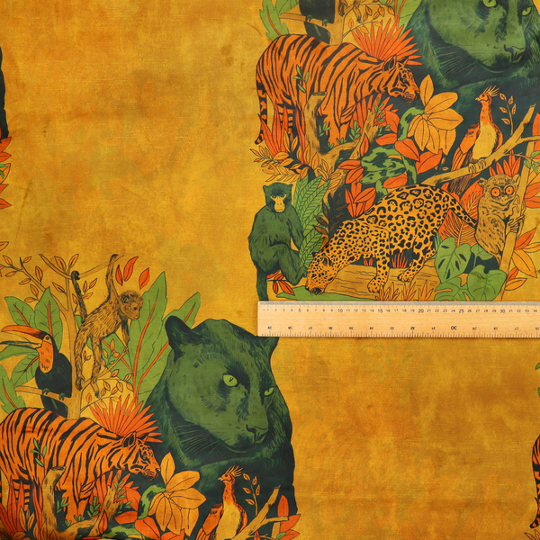 Mustard yellow fabric featuring a repeating jungle panel design with green panthers, tigers, leopards, monkeys, toucans, and lush tropical foliage.