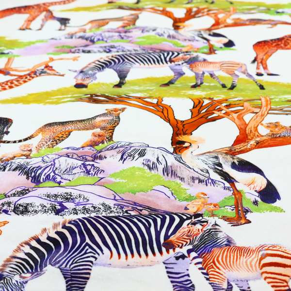 Fabric pattern featuring a vibrant African savanna landscape with giraffes, zebras, cheetahs, and birds among acacia trees and rocky terrain.