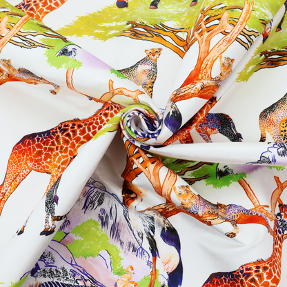Fabric pattern featuring a vibrant African savanna landscape with giraffes, zebras, cheetahs, and birds among acacia trees and rocky terrain.