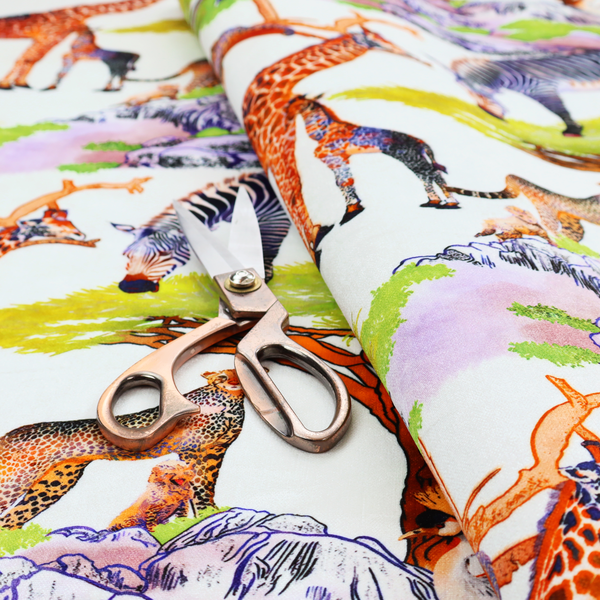 Fabric pattern featuring a vibrant African savanna landscape with giraffes, zebras, cheetahs, and birds among acacia trees and rocky terrain.