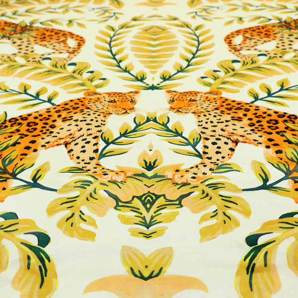 Fabric pattern featuring a symmetrical design of spotted leopards surrounded by golden and green tropical foliage and palm leaves.