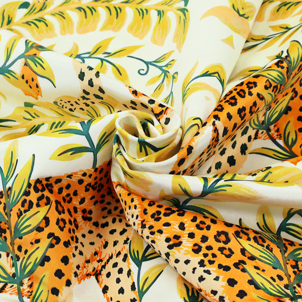 Fabric pattern featuring a symmetrical design of spotted leopards surrounded by golden and green tropical foliage and palm leaves.