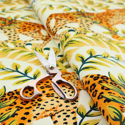 Fabric pattern featuring a symmetrical design of spotted leopards surrounded by golden and green tropical foliage and palm leaves.