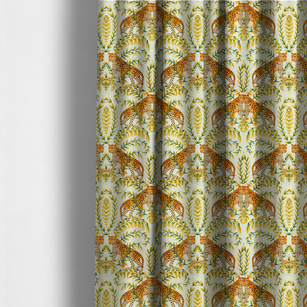 The fabric used to create these made-to-measure curtains is a symmetrical design of spotted leopards surrounded by golden and green tropical foliage and palm leaves.