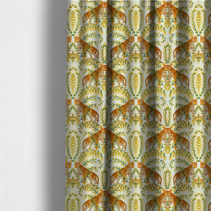 The fabric used to create these made-to-measure curtains is a symmetrical design of spotted leopards surrounded by golden and green tropical foliage and palm leaves.