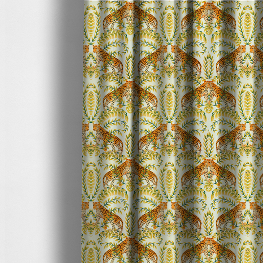 The fabric used to create these made-to-measure curtains is a symmetrical design of spotted leopards surrounded by golden and green tropical foliage and palm leaves.