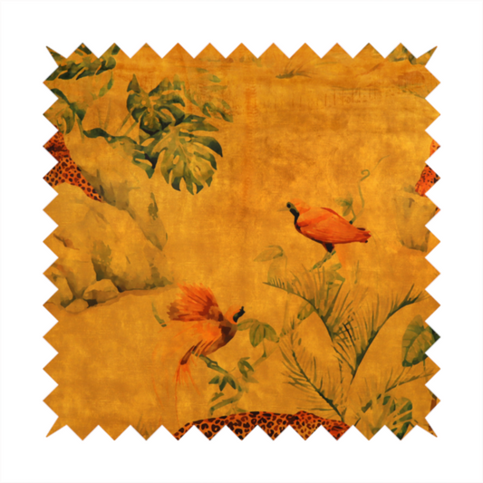 Fabric pattern featuring a warm orange and gold background with jungle wildlife, including leopards, tropical birds, large green leaves, and rocky terrain.